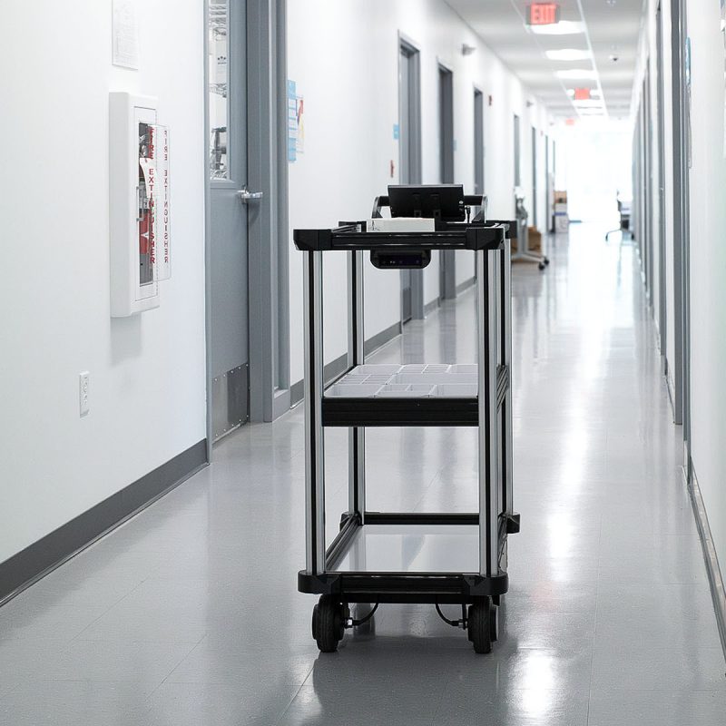 Model C2 autonomous transport robot navigates autonomously through a laboratory hallway with an intelligent sensor suite