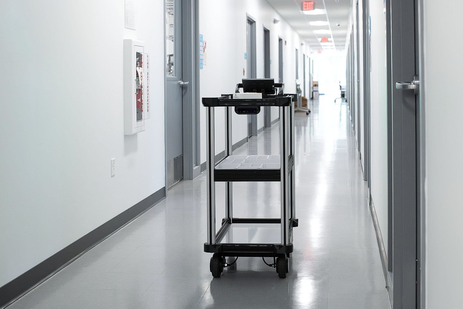 Model C2 autonomous transport robot navigates autonomously through a laboratory hallway with an intelligent sensor suite