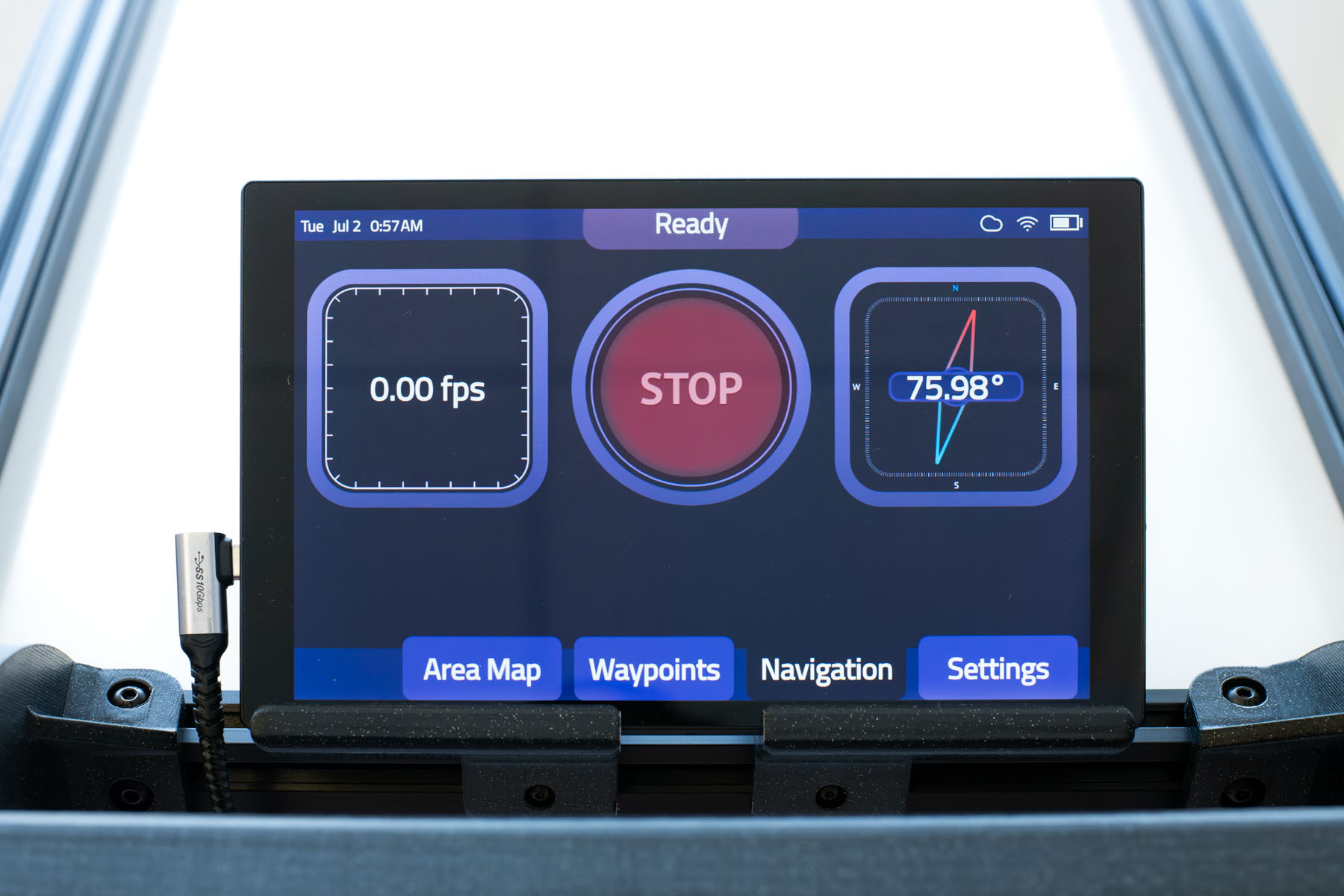 Navigation screen of the Model C2 autonomous mobile robot, showing the onboard touchscreen interface with real-time navigation metrics and emergency stop button.